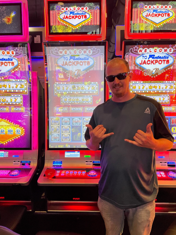 Teron S. standing in front of machine with $5,312.00 jackpot win.